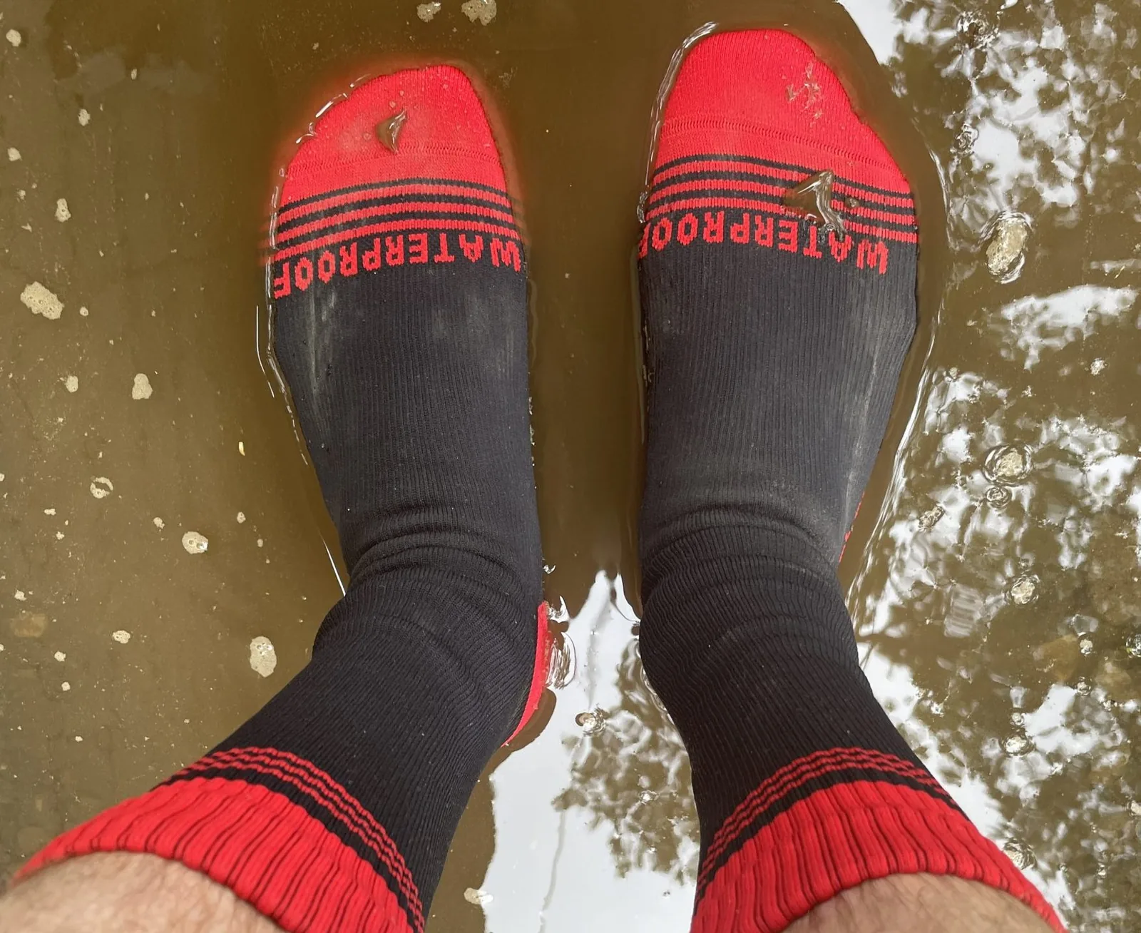 Customer waterproof socks standing in shallow water